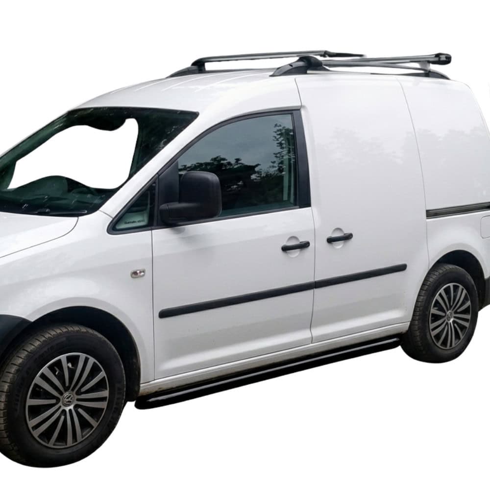White VW Caddy van with black side bars and roof rack, parked outdoors.